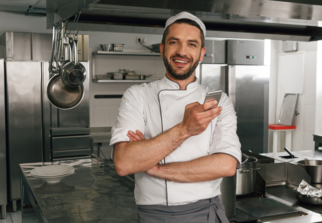 Restaurant-owner Restaurant owner on his phone texting Grease Beast